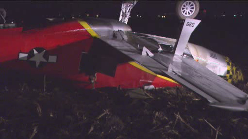 A replica of a World War II-era Mustang fighter plane flipped over as the pilot tired to land in a field in DeKalb County on Dec. 11, 2012. The pilot survived, but firefighters had to cut the plane open to free him. (Credit: CBS)