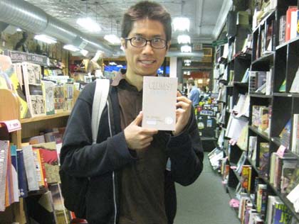 Tao Lin holds up Jeffrey Brown's Clumsy at Quimby's Bookstore. (Credit: Quimby's Bookstore's facebook)