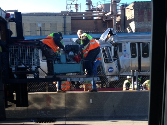 Workers assess the damage to the Blue Line cars. (Credit: Richard Wyatt/WBBM Newsradio)