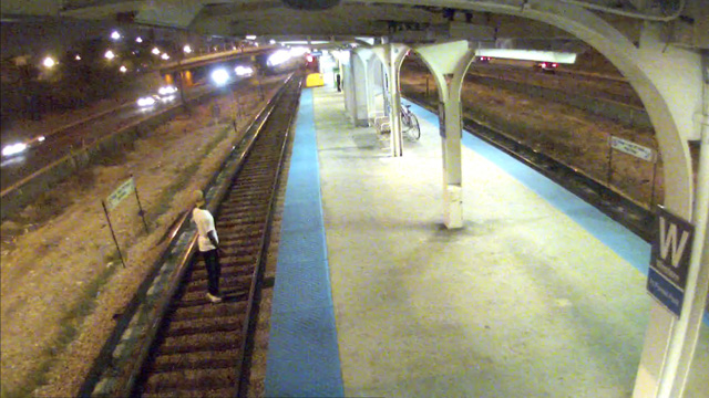 Surveillance image of a man standing on the tracks at the Western station on the CTA Blue Line. (Credit: CTA)