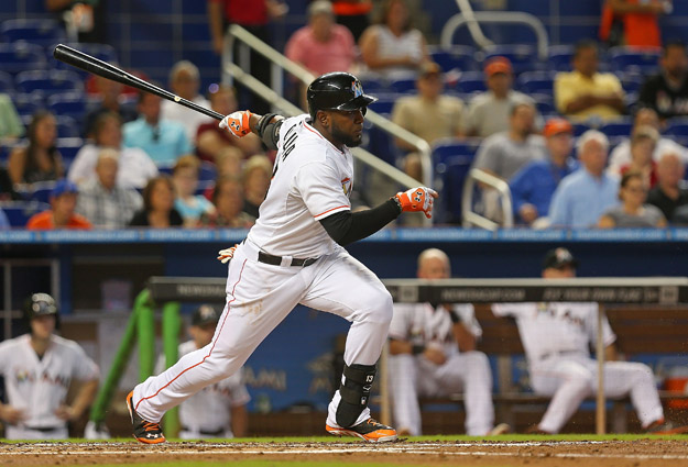 MIAMI, FL - AUGUST 20: Marcell Ozuna #13 of the Miami Marlins hits during a game against the Texas Rangers at Marlins Park on August 20, 2014 in Miami, Florida.