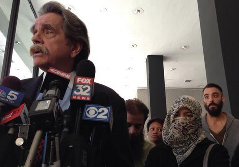 Thomas Durkin, who is defending ISIS terror suspect Mohammed Hamzah Khan, speaks with reporters at the Dirksen Federal Building. He said evidence does not support charges that Khan, 19, of Bolingbrook, intended to join the terror group. Khan's mother and father are pictured behind Durkin. (Credit: CBS)