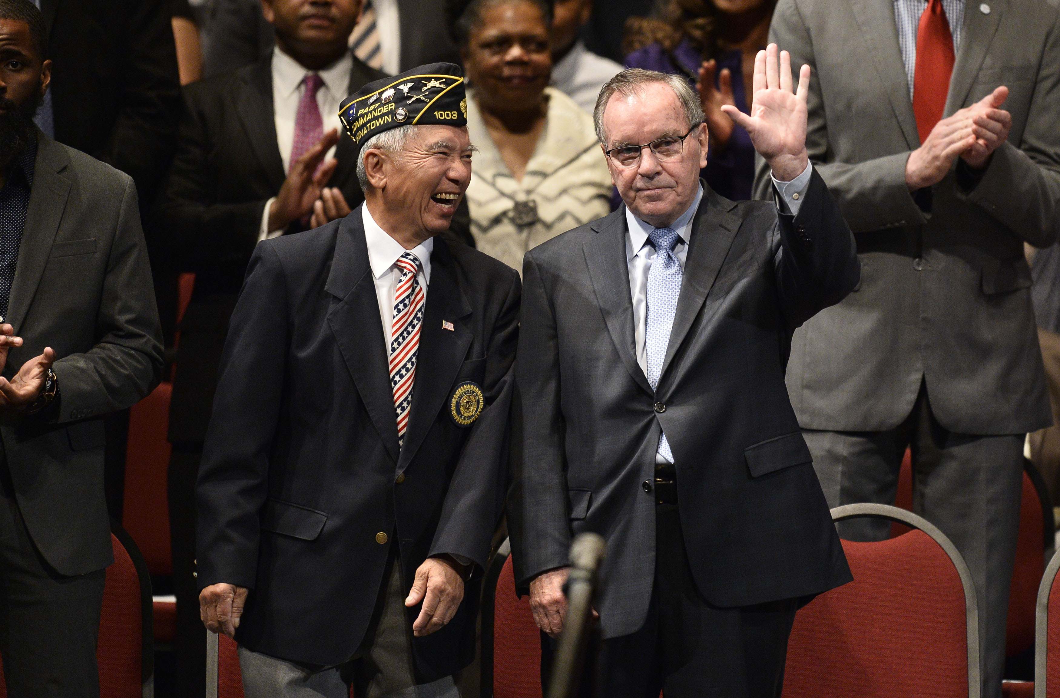 Former Chicago Mayor Richard M. Daley (R) stands with Lt. Col. Phillip Chen, retired, as he waves to the audience as he is introduced at the inauguration ceremony for Chicago Mayor Rahm Emanuel and other elected officials at the Chicago Theatre.  (Photo by Brian Kersey/Getty Images)