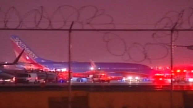 A Southwest Airlines jet sits on the tarmac at Midway International Airport, after an engine caught fire during takeoff, prompting pilots to abort the flight, and evacuate the plane. (Credit: CBS)