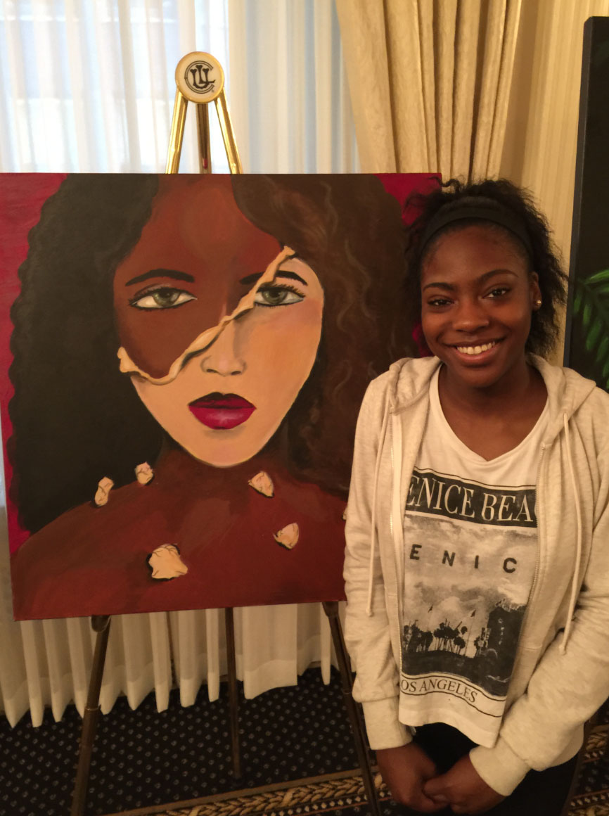 Alexis Green, 16, stands next to her work, “Two Faced." (Steve Miller/WBBM) 
